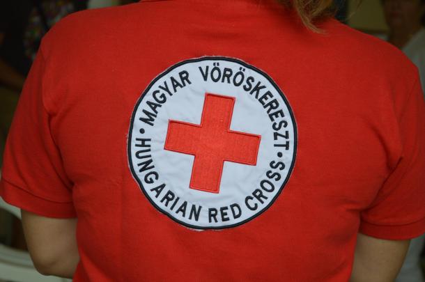 A Vöröskereszt emblémája a véradás egy szervezőjének ruháján.