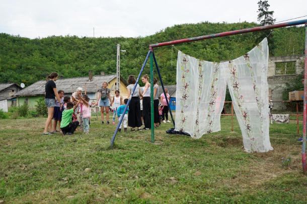 Kiserdő alján a tábor önkéntesei játszanak a gyerekekkel.