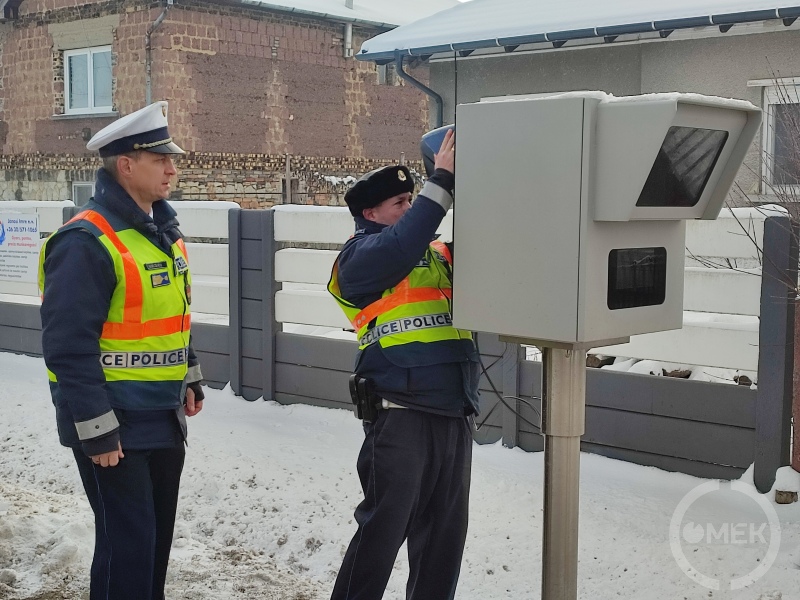 A rendőrség munkatársai elhelyezik a trafiboxban a sebességmérő eszközt.