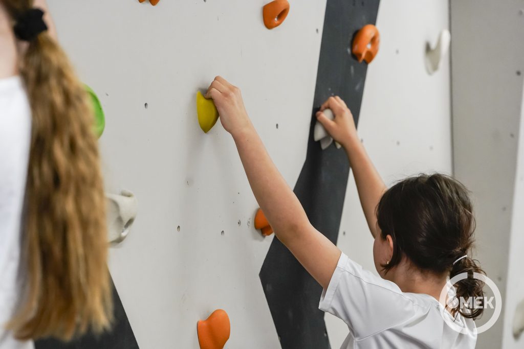 Közeli kép egy kislányról ahogyan kapaszkodik.